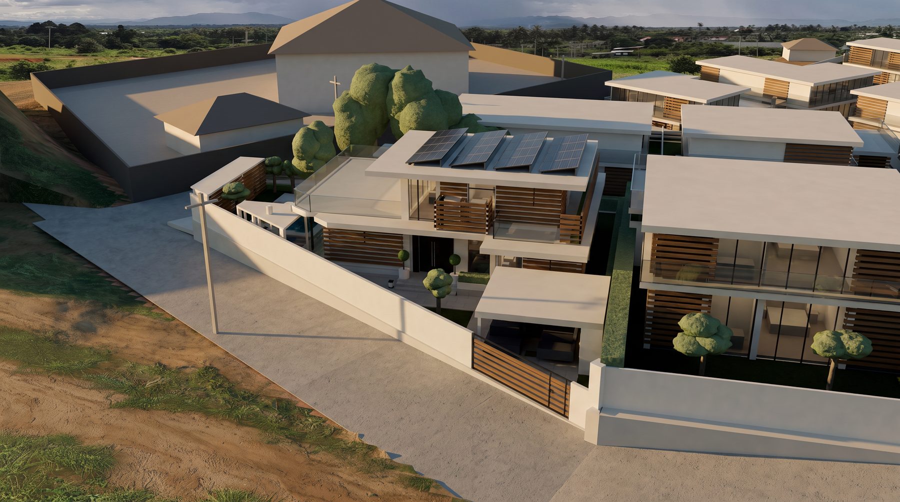 Villa A3 from above the road: solar panels over the penthouse, the roof terrace, and the walled entrance court with its carport and teak gate